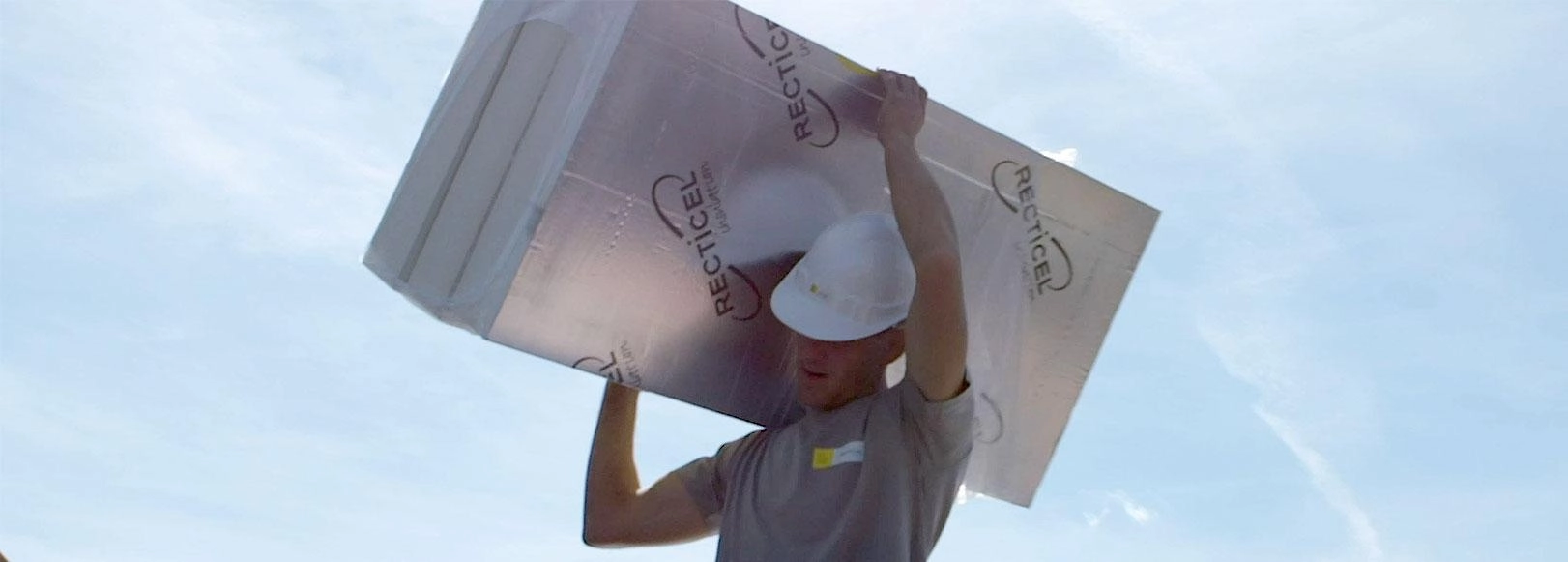 Recticel Insulation introduction banner - man on flat roof with insulation board