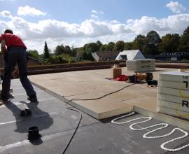 Recticel Insulation Powerdeck U panel installation image on flat roof with contractor image
