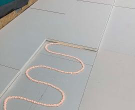 Recticel Insulation's Deck-VQ VIP insulation panel laid on a flat roof application close up high angle image with glue